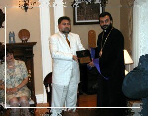 Bishop Bagrat presenting Ambassador Ara Papian with a commemorative plaque.